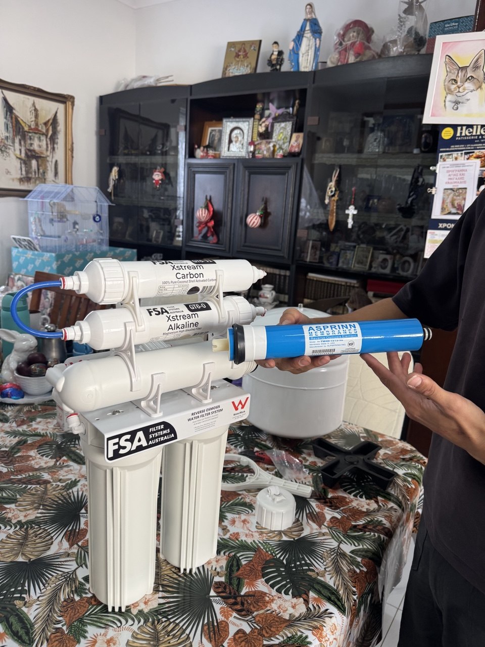 Jean-Paul installing water filter in Sydney apartment kitchen