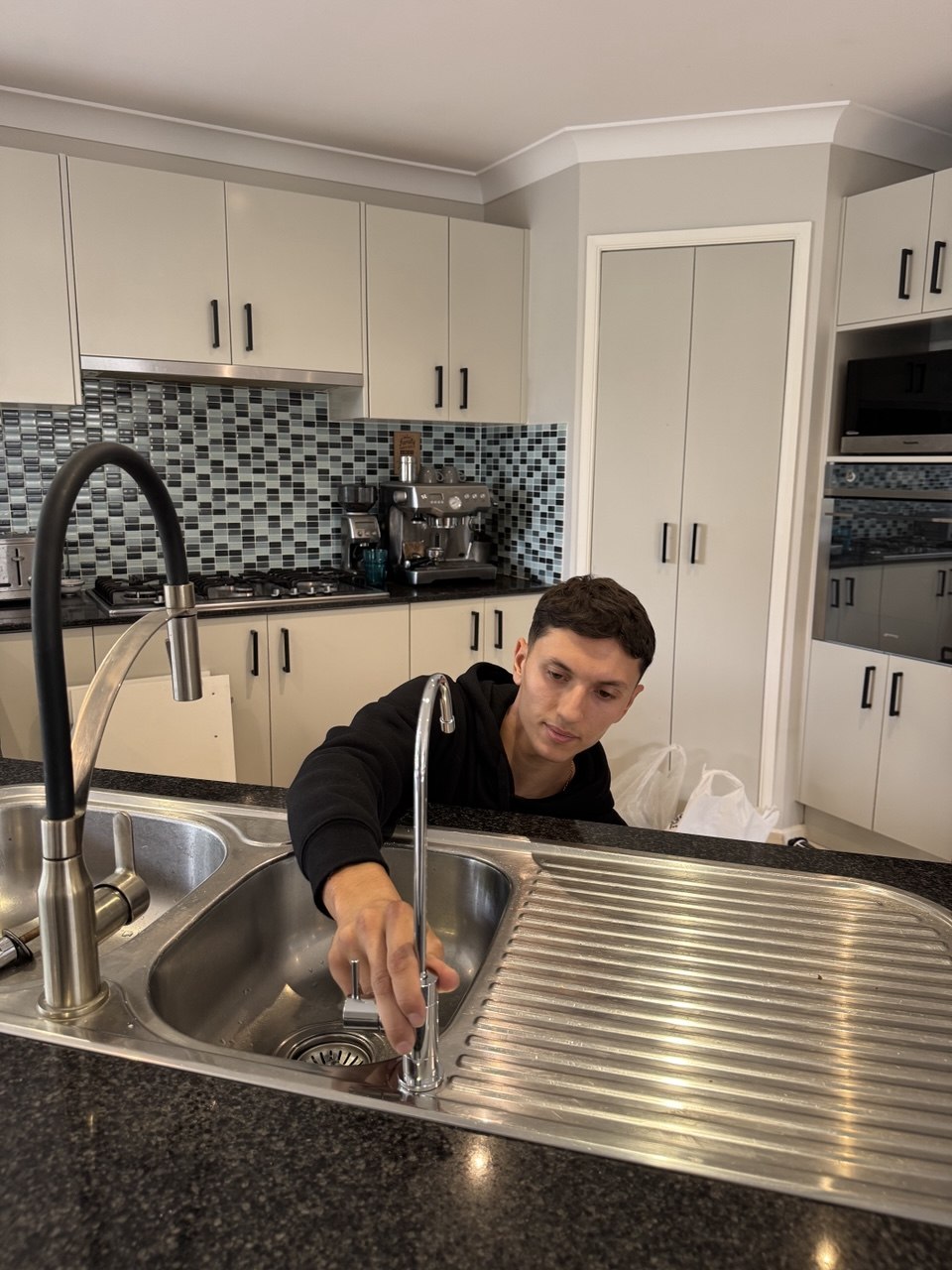Jean-Paul connecting water filter lines under sink Sydney