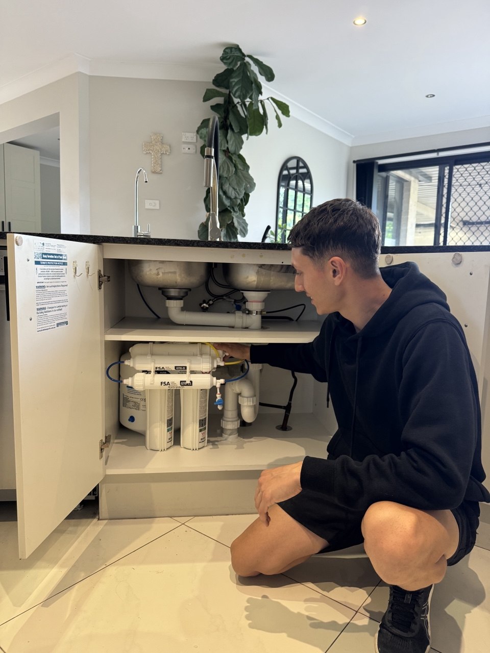 Licensed plumber completing RO filter installation Sydney