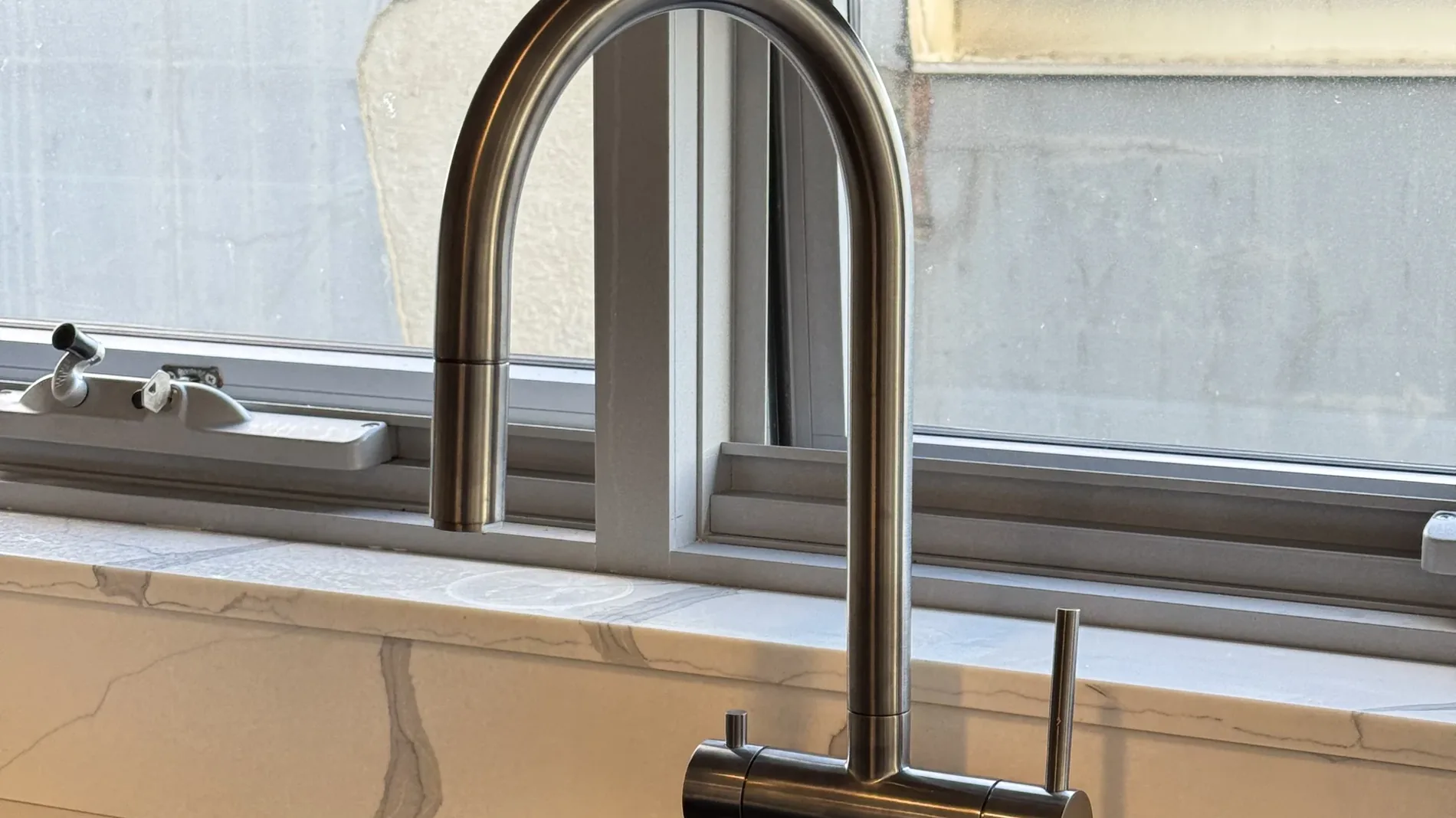 A 3 way mixer tap running filtered water in a Sydney kitchen