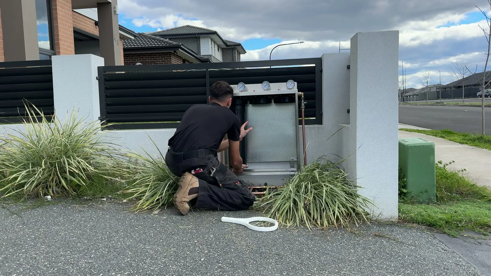 Our installer fitting a whole house filtration system outside a Sydney home